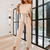 Women Trendy Outfit - Minerva | Zwarte feestelijke damesjumpsuit met gespdetail, vloeiende stof en mouwloos design voor een flatterend silhouet - Beige - S - Zarandi Amsterdam
